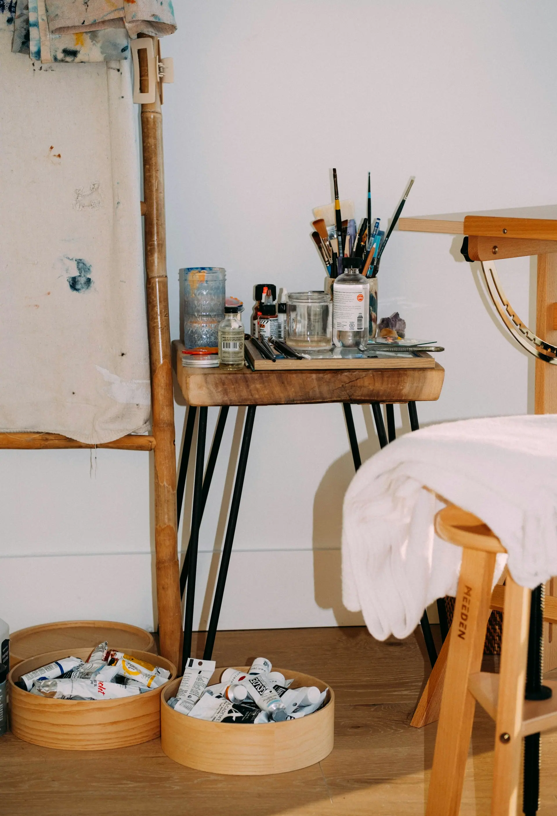 A creative studio table arranged with neutral design materials.