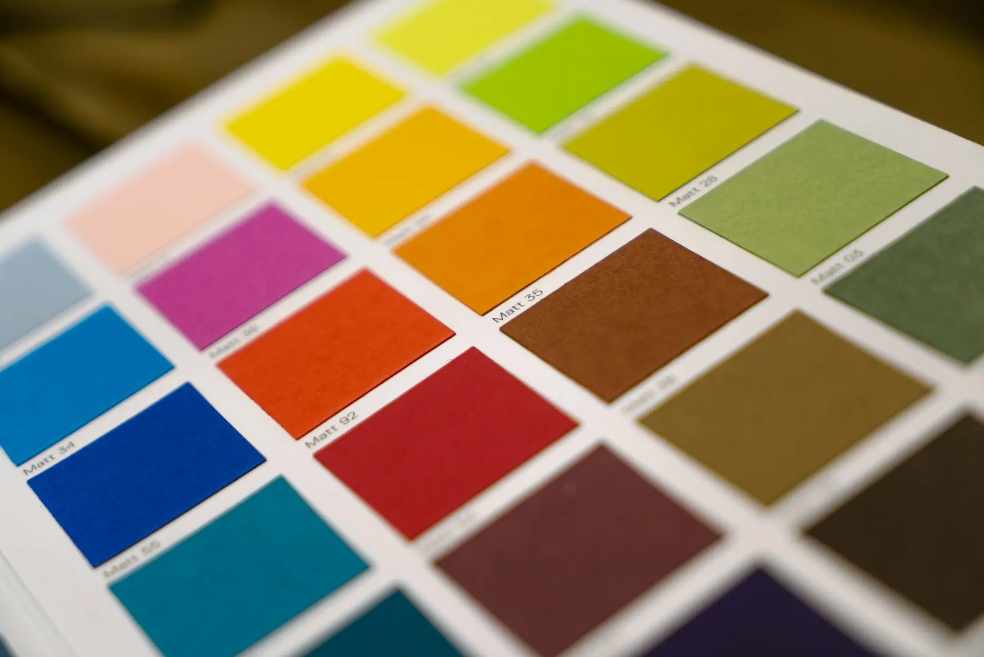Neutral paper colour swatches fanned out to study a palette.