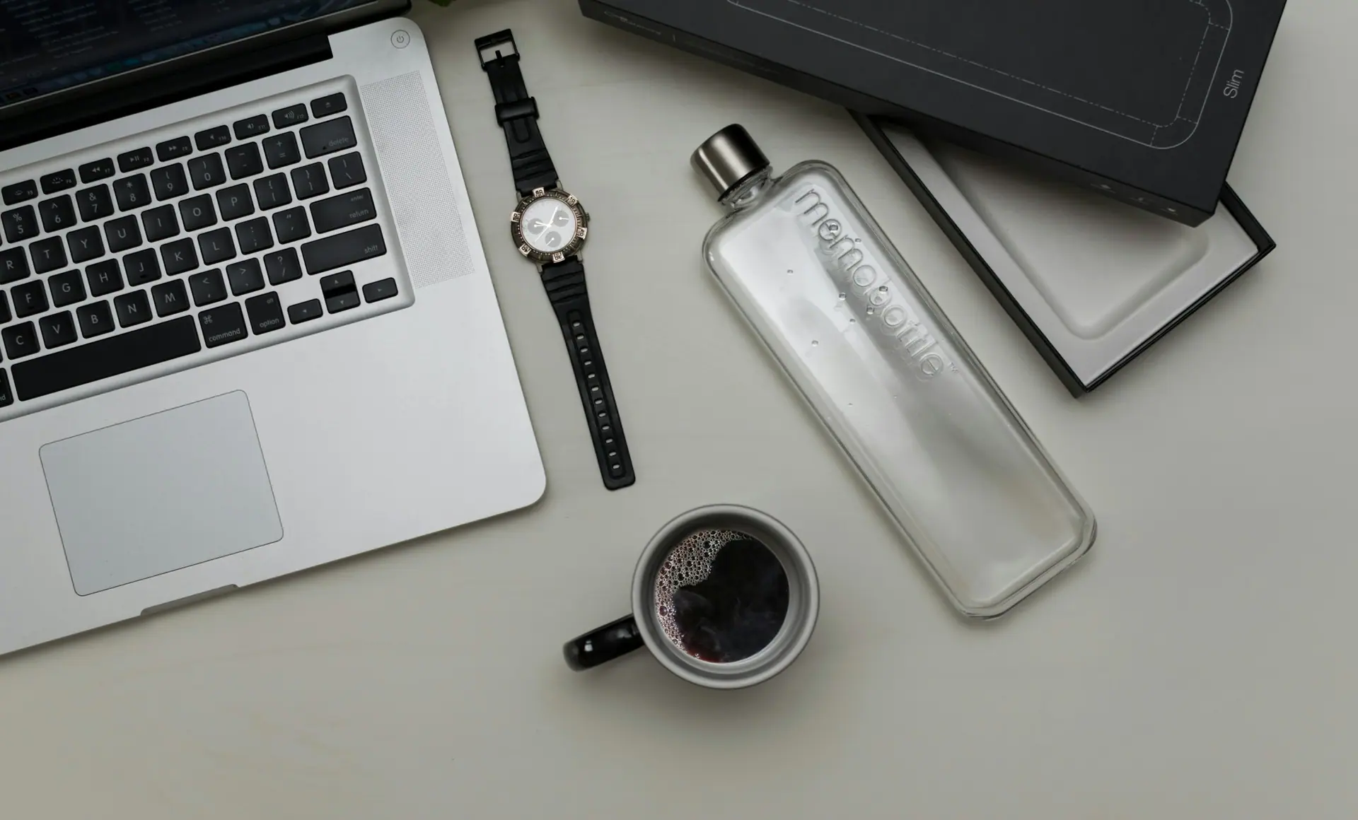 A graphic design desk with a laptop and neutral, uncluttered surroundings.